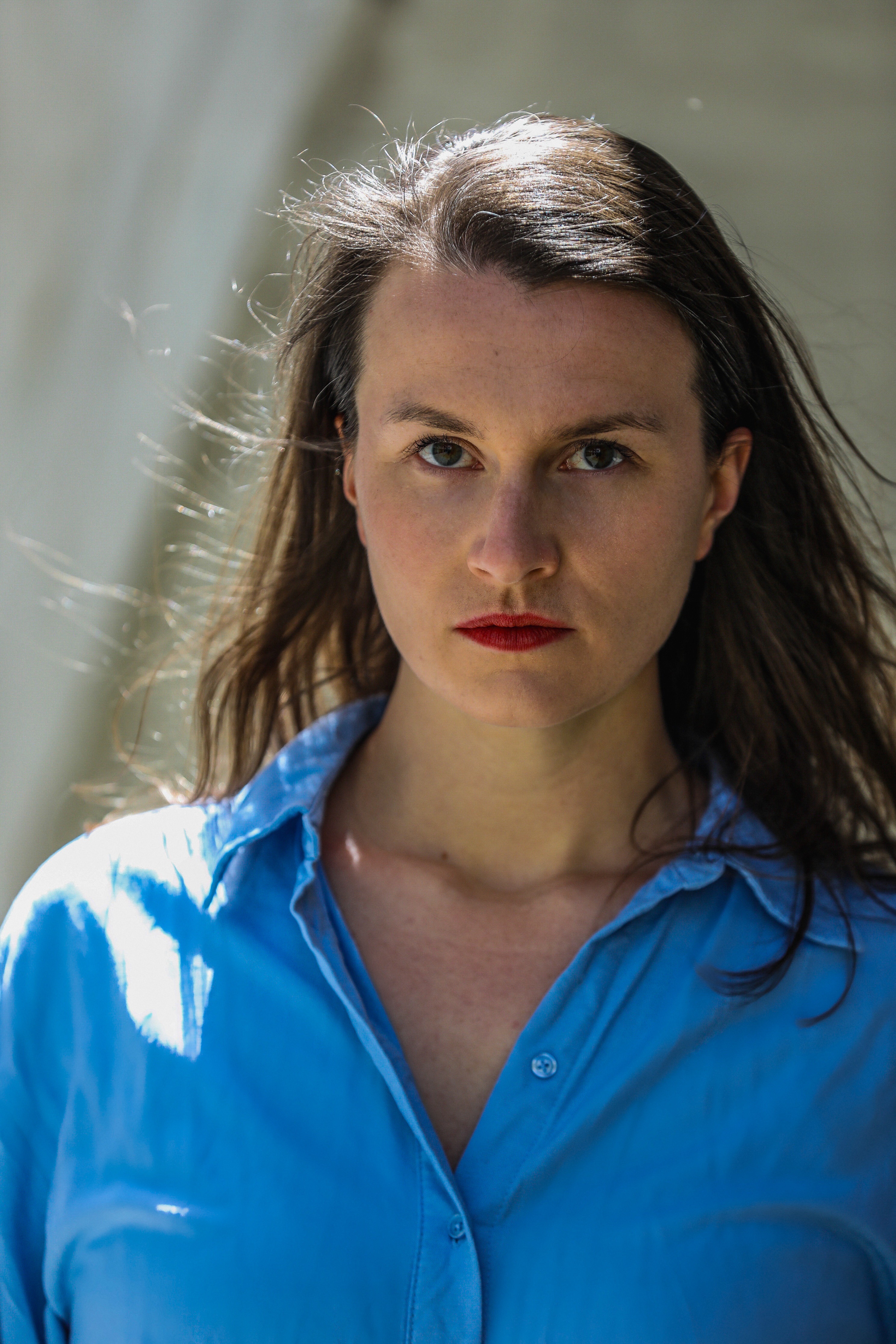 serious, with blue blouse